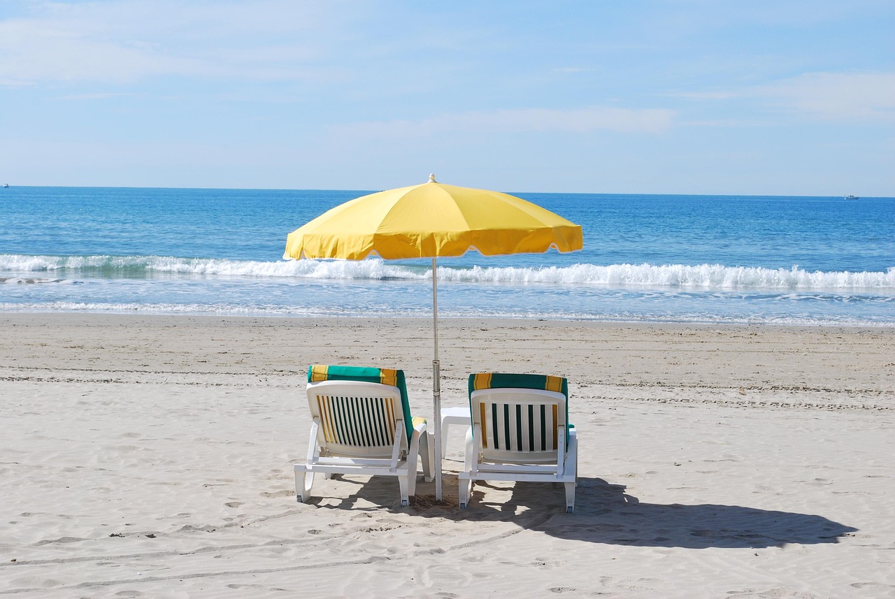 Beachfront amenities with lounge chairs and umbrella – Globe Vista hotel booking made easy and fast.