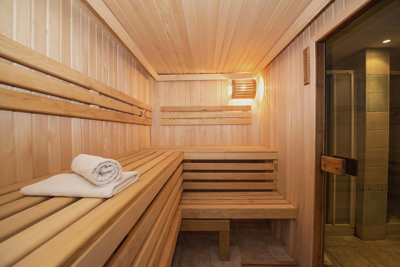 Cozy wooden sauna with folded towels in a premium hotel by Globe Vista.